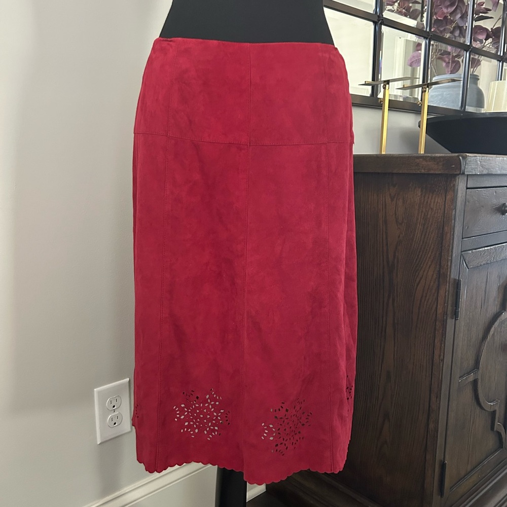 Women’s suede leather skirt with laser cutouts at the scalloped hem.